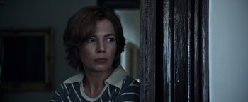 Movie still from “All the Money in the World” (2017), directed by Ridley Scott – A person with short brown hair; Close Up shot, Over the shoulder angle