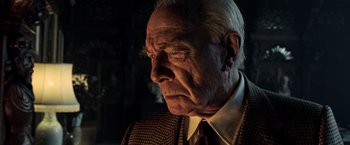 Movie still from “All the Money in the World” (2017), directed by Ridley Scott – An older man wearing a suit and a tie; Close Up shot, Low angle