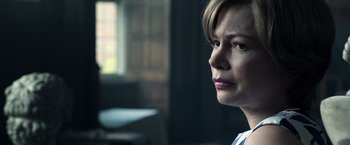 Movie still from “All the Money in the World” (2017), directed by Ridley Scott – A person with short blonde hair; Close Up shot, Over the shoulder angle