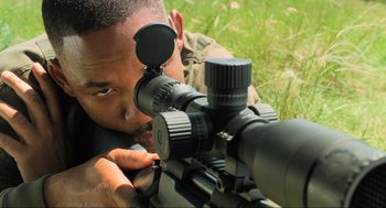 Movie still from “Gemini Man” (2019), directed by Ang Lee – A man looking through a scope on a rifle; Extreme Close Up shot, High angle