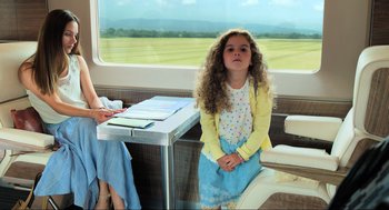 Movie still from “Gemini Man” (2019), directed by Ang Lee – A little girl sitting at a table in front of a window; Medium shot, Over the shoulder angle