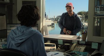 Movie still from “Gemini Man” (2019), directed by Ang Lee – A man standing in front of a mirror in front of a woman; Medium shot, Over the shoulder angle