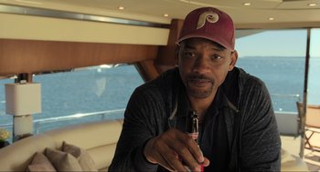 Movie still from “Gemini Man” (2019), directed by Ang Lee – A person holding a bottle of beer; Close Up shot, Over the shoulder angle