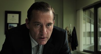 Movie still from “Gemini Man” (2019), directed by Ang Lee – A person wearing a suit and tie; Close Up shot, Low angle