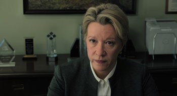 Movie still from “Gemini Man” (2019), directed by Ang Lee – A person sitting at a desk; Close Up shot, Low angle