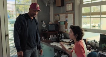 Movie still from “Gemini Man” (2019), directed by Ang Lee – A man and a woman are talking in a kitchen; Medium shot, Over the shoulder angle