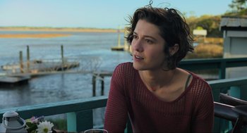 Movie still from “Gemini Man” (2019), directed by Ang Lee – A woman sitting at a table looking out at the water; Close Up shot, Over the shoulder angle
