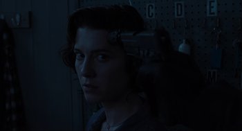 Movie still from “Gemini Man” (2019), directed by Ang Lee – A person with a gun in a room; Close Up shot, Over the shoulder angle