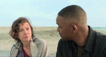 Movie still from “Gemini Man” (2019), directed by Ang Lee – A man and a woman sitting on the beach; Close Up shot, Low angle