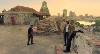 Movie still from “Gemini Man” (2019), directed by Ang Lee – A group of men standing on top of a brick wall; Extreme Wide shot, High angle