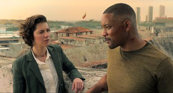 Movie still from “Gemini Man” (2019), directed by Ang Lee – A man and a woman are talking on a balcony; Medium shot, Over the shoulder angle