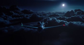 Movie still from “Gemini Man” (2019), directed by Ang Lee – An airplane is flying through the night sky; Extreme Wide shot, High angle