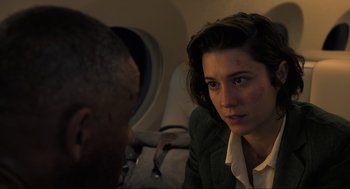 Movie still from “Gemini Man” (2019), directed by Ang Lee – A woman sitting next to a man on a plane; Close Up shot, Over the shoulder angle