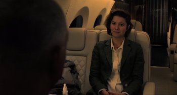 Movie still from “Gemini Man” (2019), directed by Ang Lee – A woman sitting on a seat on an airplane; Medium shot, Over the shoulder angle