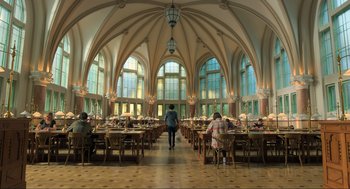 Movie still from “Gemini Man” (2019), directed by Ang Lee – People are sitting at tables in a large dining hall; Extreme Wide shot, High angle