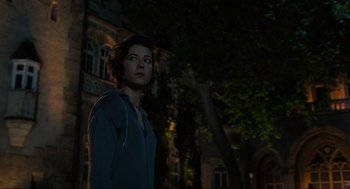 Movie still from “Gemini Man” (2019), directed by Ang Lee – A woman standing in the dark near a building; Medium shot, Low angle