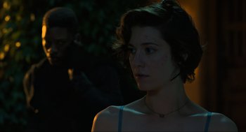 Movie still from “Gemini Man” (2019), directed by Ang Lee – A young woman with short dark brown hair wearing a blue top; Close Up shot, Over the shoulder angle