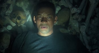 Movie still from “Gemini Man” (2019), directed by Ang Lee – A person in a cave with rocks; Close Up shot, High angle