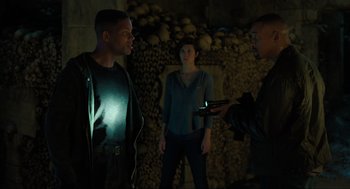Movie still from “Gemini Man” (2019), directed by Ang Lee – A group of people standing next to each other in a room; Medium shot, Over the shoulder angle