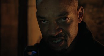 Movie still from “Gemini Man” (2019), directed by Ang Lee – A person with a cell phone; Close Up shot, Low angle