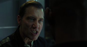 Movie still from “Gemini Man” (2019), directed by Ang Lee – A person with a angry look on his face; Close Up shot, Over the shoulder angle