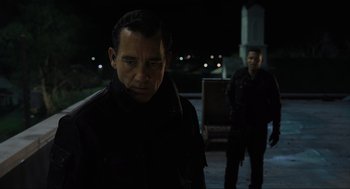 Movie still from “Gemini Man” (2019), directed by Ang Lee – A man in black jacket standing next to another man in black jacket; Medium shot, Over the shoulder angle