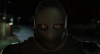 Movie still from “Gemini Man” (2019), directed by Ang Lee – A person wearing a helmet and a black mask; Close Up shot, Low angle