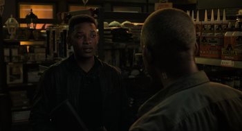 Movie still from “Gemini Man” (2019), directed by Ang Lee – Two men are talking to each other in a garage; Medium shot, Over the shoulder angle
