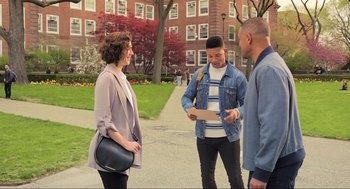 Movie still from “Gemini Man” (2019), directed by Ang Lee – A group of people standing on a sidewalk near a building; Wide shot, High angle