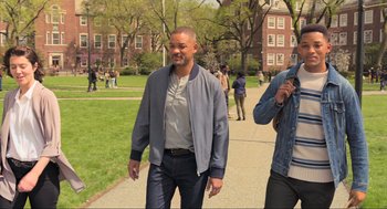 Movie still from “Gemini Man” (2019), directed by Ang Lee – A man walking down a sidewalk near a building; Wide shot, High angle