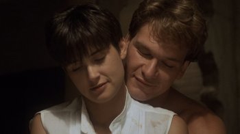 Movie still from “Ghost” (1990), directed by Jerry Zucker – A man and a woman embracing each other in a room; Close Up shot, Low angle