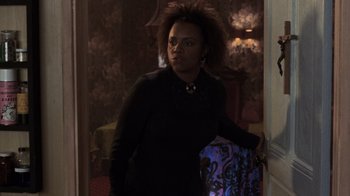 Movie still from “Ghost” (1990), directed by Jerry Zucker – A woman standing in front of a doorway; Medium shot, Over the shoulder angle