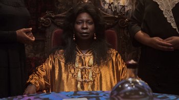 Movie still from “Ghost” (1990), directed by Jerry Zucker – A woman sitting at a table in front of an ornate chair; Close Up shot, Low angle