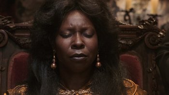 Movie still from “Ghost” (1990), directed by Jerry Zucker – A woman with long black hair is sitting in a chair with her eyes closed; Close Up shot, High angle