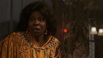 Movie still from “Ghost” (1990), directed by Jerry Zucker – An older woman in a yellow dress with a surprised look on her face; Close Up shot, Low angle