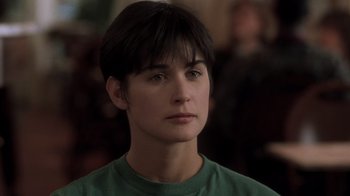 Movie still from “Ghost” (1990), directed by Jerry Zucker – A person wearing a green shirt; Close Up shot, Over the shoulder angle