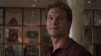 Movie still from “Ghost” (1990), directed by Jerry Zucker – A person wearing a red shirt; Close Up shot, Low angle