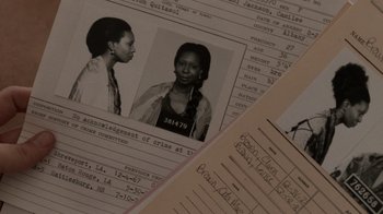 Movie still from “Ghost” (1990), directed by Jerry Zucker – An old photo of a woman in a prison outfit; Extreme Close Up shot, High angle
