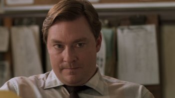 Movie still from “Ghost” (1990), directed by Jerry Zucker – A person wearing a shirt and tie; Close Up shot, Over the shoulder angle