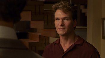 Movie still from “Ghost” (1990), directed by Jerry Zucker – A person wearing a red shirt; Close Up shot, Low angle