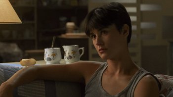 Movie still from “Ghost” (1990), directed by Jerry Zucker – A woman sitting in front of two coffee cups; Close Up shot, High angle