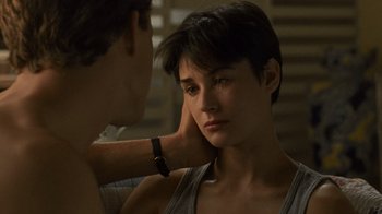 Movie still from “Ghost” (1990), directed by Jerry Zucker – A woman sitting next to a man in a room; Close Up shot, Over the shoulder angle