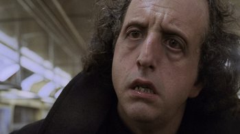 Movie still from “Ghost” (1990), directed by Jerry Zucker – A person with curly hair; Close Up shot, Low angle