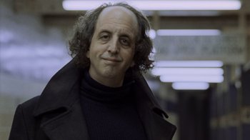 Movie still from “Ghost” (1990), directed by Jerry Zucker – A person wearing a black jacket; Close Up shot, Low angle