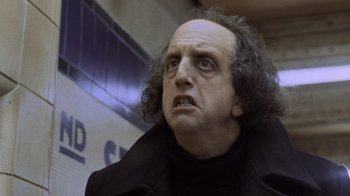 Movie still from “Ghost” (1990), directed by Jerry Zucker – A man with a bald head is looking at the camera; Close Up shot, Low angle