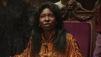 Movie still from “Ghost” (1990), directed by Jerry Zucker – A woman with long black hair wearing a yellow and orange dress; Close Up shot, Low angle