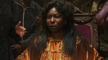 Movie still from “Ghost” (1990), directed by Jerry Zucker – A woman with long black hair sitting in a chair; Close Up shot, Over the shoulder angle