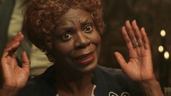 Movie still from “Ghost” (1990), directed by Jerry Zucker – An older woman with a surprised look on her face; Close Up shot, Low angle