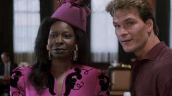 Movie still from “Ghost” (1990), directed by Jerry Zucker – A man and a woman in a pink dress and hat; Close Up shot, Over the shoulder angle
