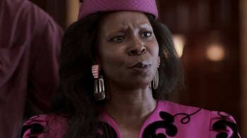Movie still from “Ghost” (1990), directed by Jerry Zucker – A woman in a pink dress and a pink hat; Close Up shot, Low angle